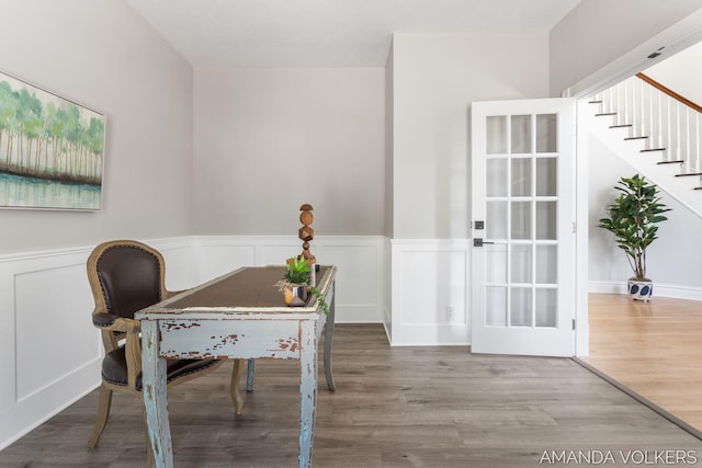 8608 Woodruff Dr SW, Byron Center, MI 49315 - home office featuring a wainscoted wall, wood finished floors, and a decorative wall