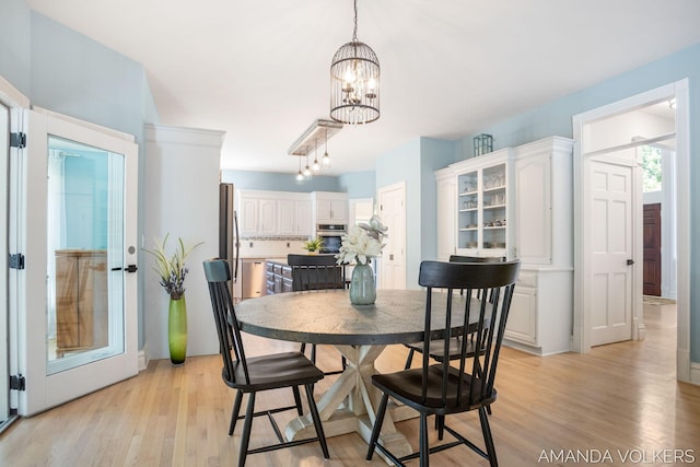 8608 Woodruff Dr SW, Byron Center, MI 49315 - dining space featuring a chandelier and light wood-style flooring