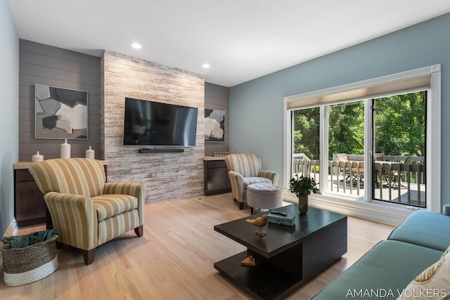 8608 Woodruff Dr SW, Byron Center, MI 49315 - living room with wood finished floors, recessed lighting, wood walls, and an accent wall