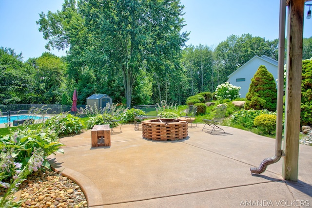 8608 Woodruff Dr SW, Byron Center, MI 49315 - view of patio featuring an outdoor fire pit, a shed, and view of scattered trees