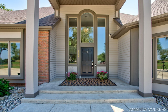 8608 Woodruff Dr SW, Byron Center, MI 49315 - entrance to property with a shingled roof, brick siding, and covered porch