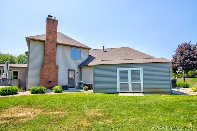 8608 Woodruff Dr SW, Byron Center, MI 49315 - back of house with a chimney, a lawn, and roof with shingles