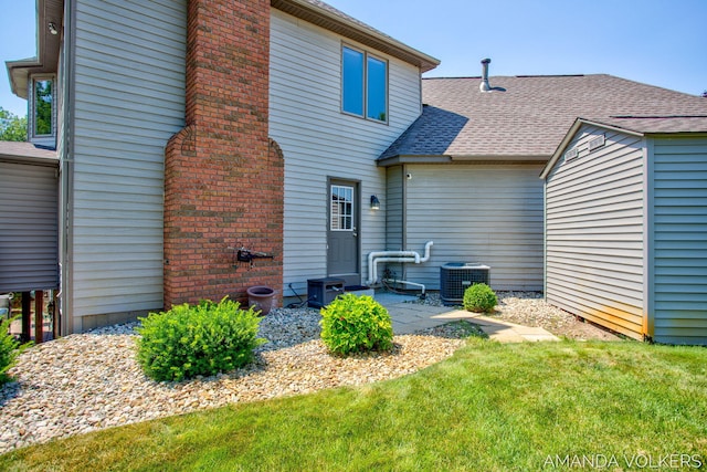 8608 Woodruff Dr SW, Byron Center, MI 49315 - rear view of property featuring a shingled roof and a lawn