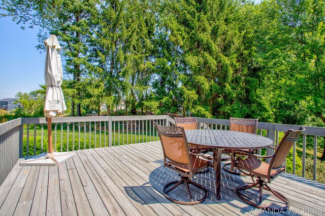 8608 Woodruff Dr SW, Byron Center, MI 49315 - deck with outdoor dining area and a lawn