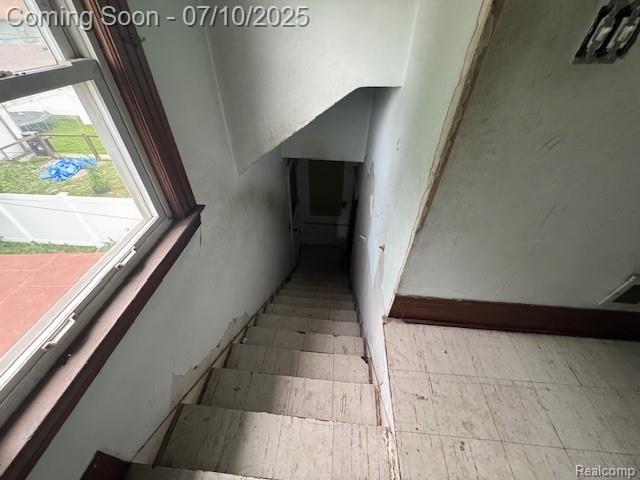 566 Elm St, Wyandotte, MI 48192 - staircase with plenty of natural light and tile patterned floors