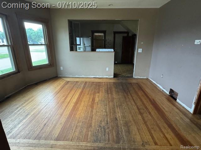 566 Elm St, Wyandotte, MI 48192 - unfurnished room with wood-type flooring and baseboards