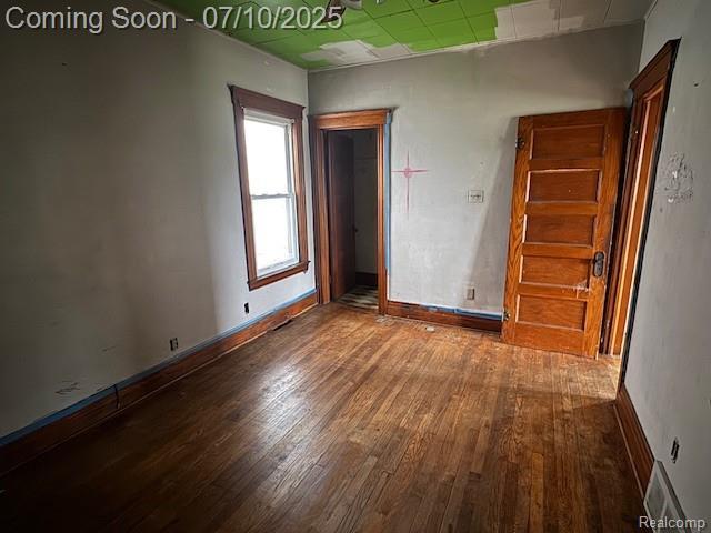 566 Elm St, Wyandotte, MI 48192 - spare room with wood finished floors and baseboards