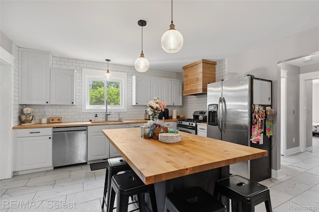 1406 Country View Ln, Flint, MI 48532 - kitchen featuring appliances with stainless steel finishes, wood counters, light marble finish floors, and tasteful backsplash