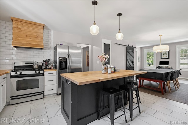 1406 Country View Ln, Flint, MI 48532 - kitchen featuring appliances with stainless steel finishes, butcher block counters, a barn door, light marble finish floors, and white cabinetry