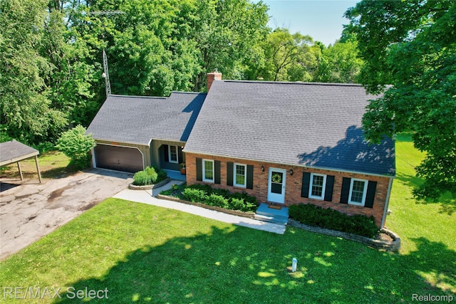 1406 Country View Ln, Flint, MI 48532 - new england style home featuring asphalt driveway, a front yard, an attached garage, and brick siding
