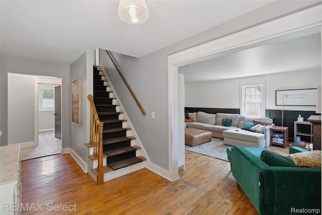 1406 Country View Ln, Flint, MI 48532 - living area featuring stairs, light wood-style flooring, and healthy amount of natural light
