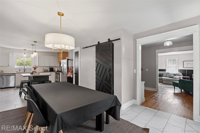 1406 Country View Ln, Flint, MI 48532 - dining space featuring a barn door and light marble finish flooring