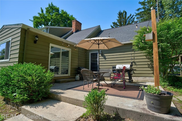 1406 Country View Ln, Flint, MI 48532 - back of house with a chimney, a patio area, and outdoor dining area