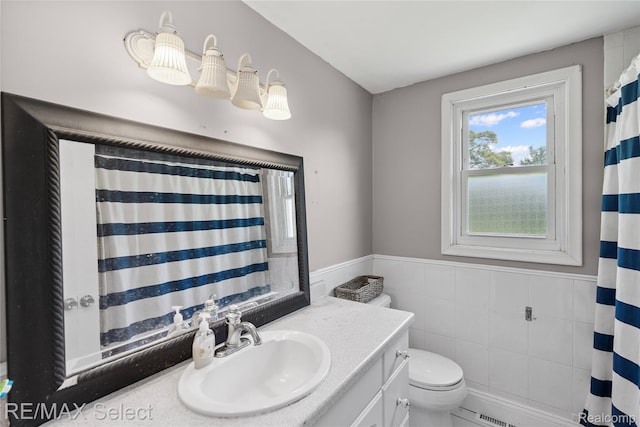 1406 Country View Ln, Flint, MI 48532 - bathroom featuring vanity, tile walls, and a wainscoted wall