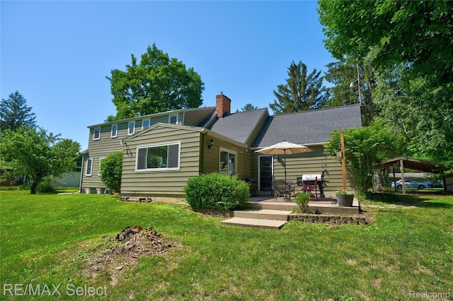 1406 Country View Ln, Flint, MI 48532 - rear view of property with a chimney, a lawn, and a patio area