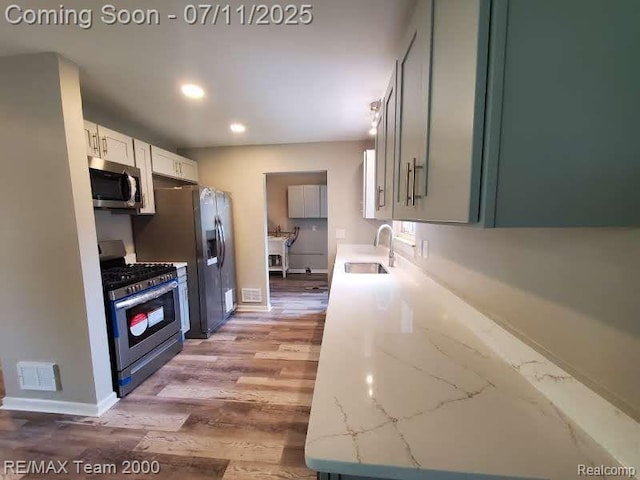4638 Gertrude St, Dearborn Heights, MI 48125 - kitchen featuring stainless steel appliances, recessed lighting, light wood-style flooring, and light stone counters
