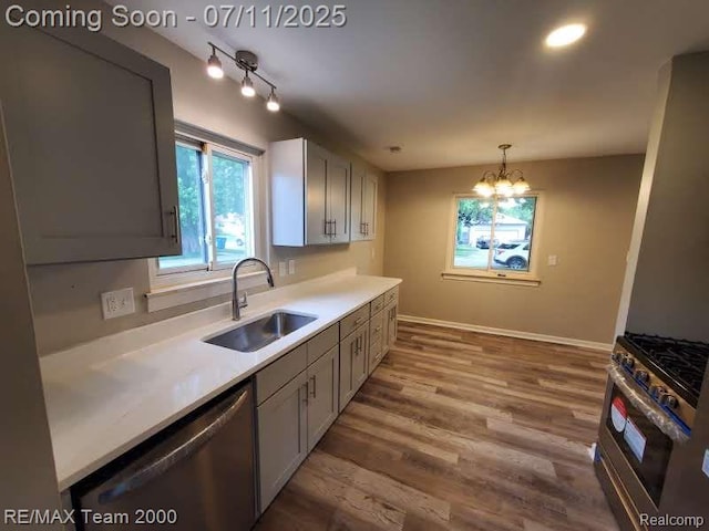 4638 Gertrude St, Dearborn Heights, MI 48125 - kitchen with appliances with stainless steel finishes, light countertops, wood finished floors, decorative light fixtures, and a chandelier