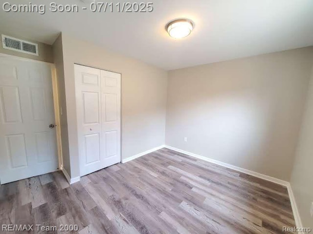 4638 Gertrude St, Dearborn Heights, MI 48125 - unfurnished bedroom with wood finished floors and a closet