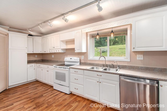 6047 Belding Rd, Belding, MI 48809 - kitchen featuring stainless steel dishwasher, white range with electric stovetop, rail lighting, and white cabinets