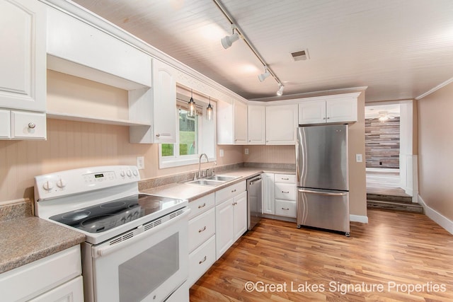 6047 Belding Rd, Belding, MI 48809 - kitchen featuring stainless steel appliances, white cabinetry, track lighting, and light wood-type flooring