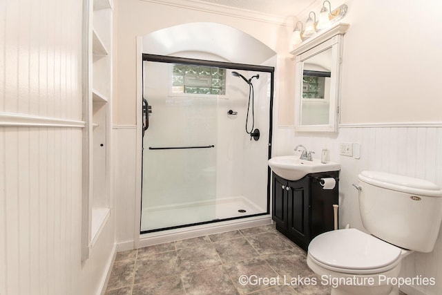 6047 Belding Rd, Belding, MI 48809 - full bath with a shower with shower door, vanity, wainscoting, stone finish floors, and ornamental molding