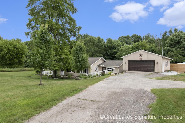 6047 Belding Rd, Belding, MI 48809 - view of front of home featuring a front yard and a detached garage