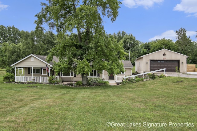 6047 Belding Rd, Belding, MI 48809 - view of front facade with a porch, a detached garage, and a front yard