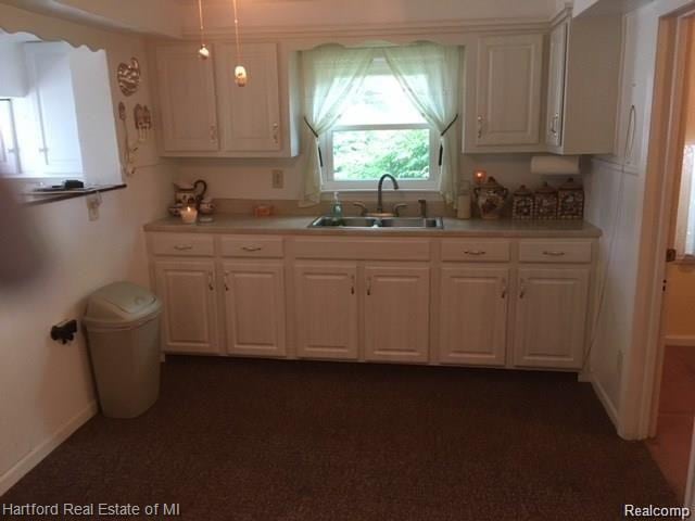 7170 Kempa Ave, Romulus, MI 48174 - kitchen featuring light countertops, pendant lighting, and white cabinetry