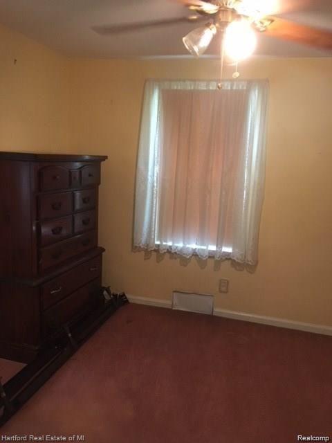 7170 Kempa Ave, Romulus, MI 48174 - carpeted spare room with a ceiling fan and baseboards