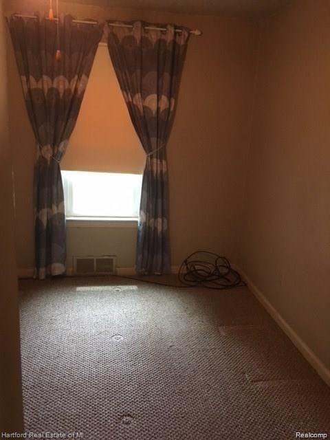7170 Kempa Ave, Romulus, MI 48174 - spare room featuring carpet flooring and baseboards