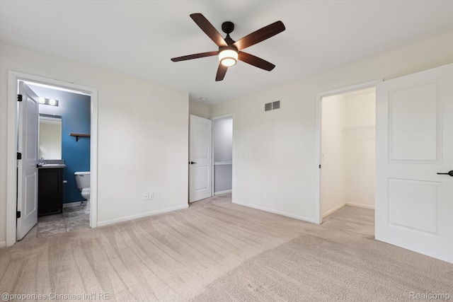 1051 N Sherman Dr Unit B19, Royal Oak, MI 48067 - unfurnished bedroom with carpet floors, a walk in closet, connected bathroom, and ceiling fan