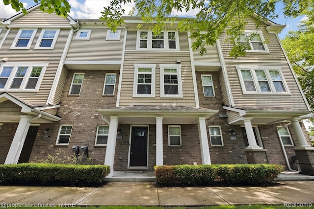 1051 N Sherman Dr Unit B19, Royal Oak, MI 48067 - view of front of home featuring brick siding and covered porch