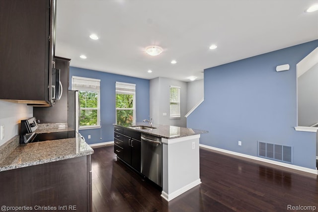 1051 N Sherman Dr Unit B19, Royal Oak, MI 48067 - kitchen featuring stainless steel appliances, a kitchen island with sink, dark wood-style floors, dark brown cabinetry, and recessed lighting