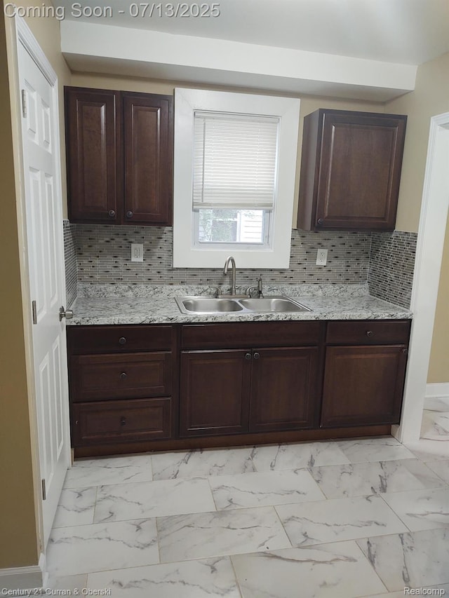 19928 Avon Ave, Detroit, MI 48219 - kitchen featuring light marble finish flooring, dark brown cabinets, decorative backsplash, and light stone counters