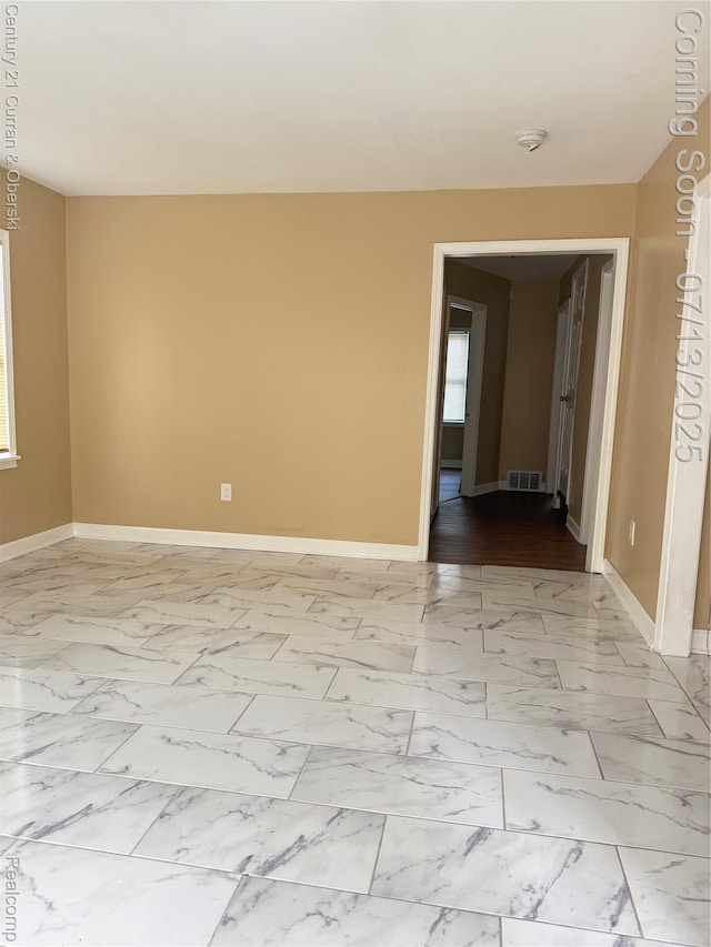 19928 Avon Ave, Detroit, MI 48219 - empty room with a smoke detector, marble look tile flooring, and plenty of natural light