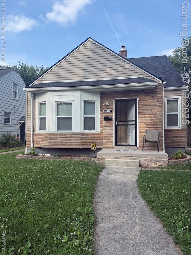 19928 Avon Ave, Detroit, MI 48219 - bungalow-style home featuring a chimney, a front yard, and stone siding