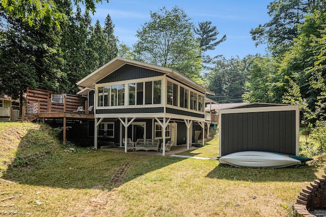 6706 E Carrigan Dr, Newaygo, MI 49337 - rear view of property with a deck, a patio area, a yard, a sunroom, and a shed