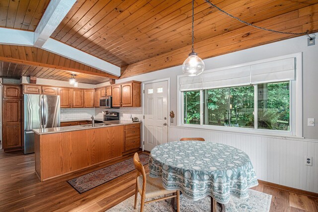 6706 E Carrigan Dr, Newaygo, MI 49337 - kitchen with stainless steel appliances, a peninsula, brown cabinetry, dark wood-style floors, and wood ceiling