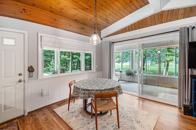 6706 E Carrigan Dr, Newaygo, MI 49337 - dining space with lofted ceiling, wood ceiling, wood finished floors, and wooden walls