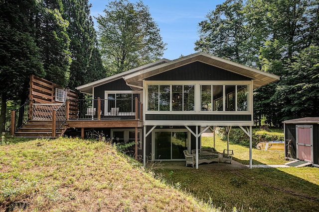 6706 E Carrigan Dr, Newaygo, MI 49337 - back of property with a shed, a sunroom, a wooden deck, and a lawn