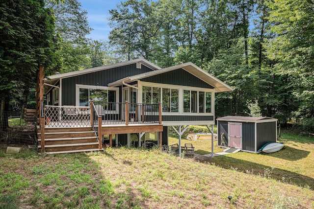 6706 E Carrigan Dr, Newaygo, MI 49337 - view of front facade with a shed, a sunroom, a deck, and a front yard