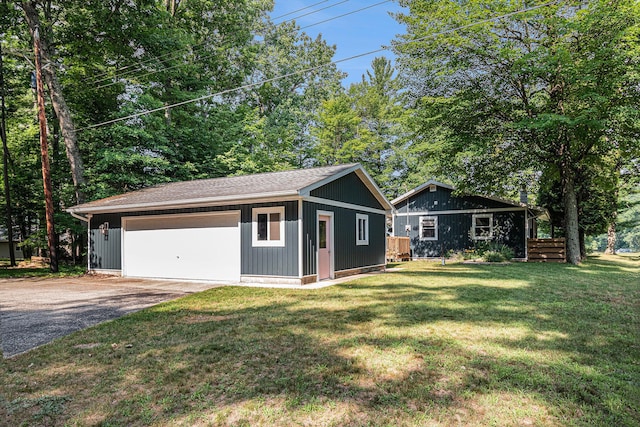 6706 E Carrigan Dr, Newaygo, MI 49337 - view of front of home with a front lawn, an outbuilding, and a detached garage