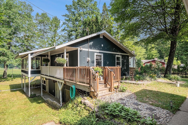 6706 E Carrigan Dr, Newaygo, MI 49337 - rear view of house with a lawn and a wooden deck