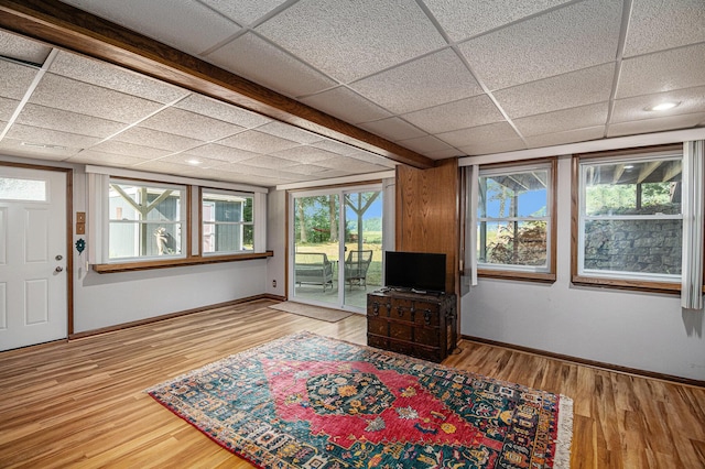 6706 E Carrigan Dr, Newaygo, MI 49337 - unfurnished living room with wood finished floors and a drop ceiling