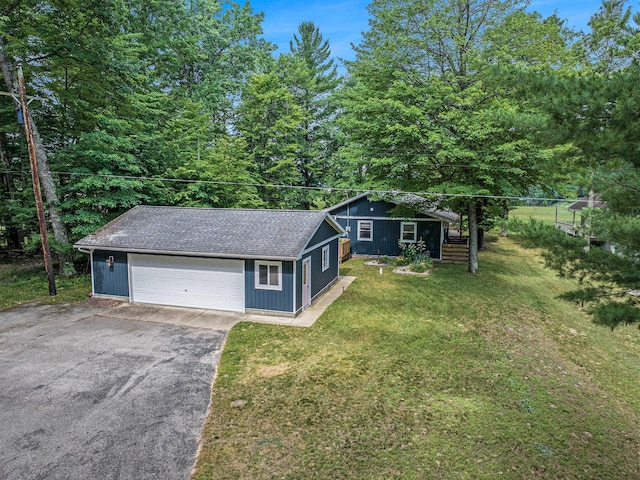 6706 E Carrigan Dr, Newaygo, MI 49337 - view of front of home with a detached garage, a front yard, an outdoor structure, and a shingled roof
