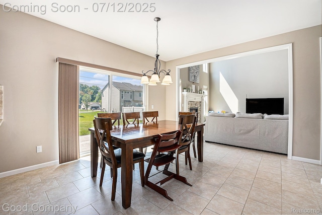 2920 Hartline Dr, Rochester Hills, MI 48309 - dining area with a chandelier, light tile patterned flooring, and a stone fireplace