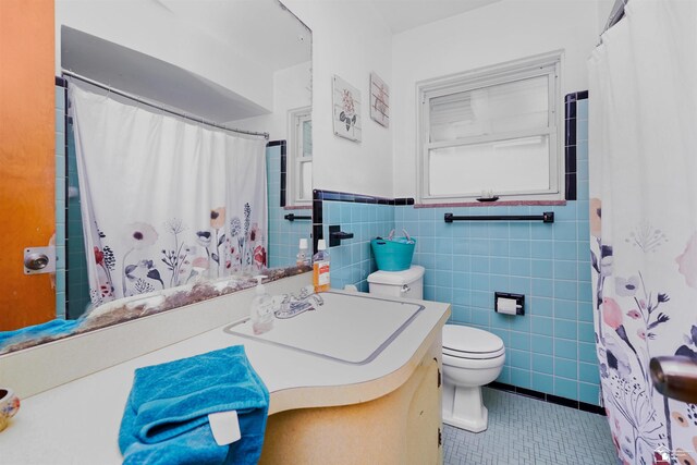 8124 Bailey St, Taylor, MI 48101 - bathroom with tile patterned floors, vanity, tile walls, a wainscoted wall, and a shower with shower curtain