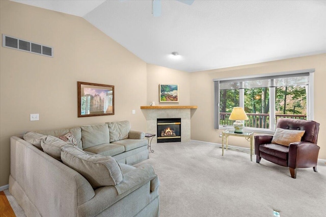 9650 Killdeer Ct, Canadian Lakes, MI 49346 - carpeted living room with vaulted ceiling and a tile fireplace