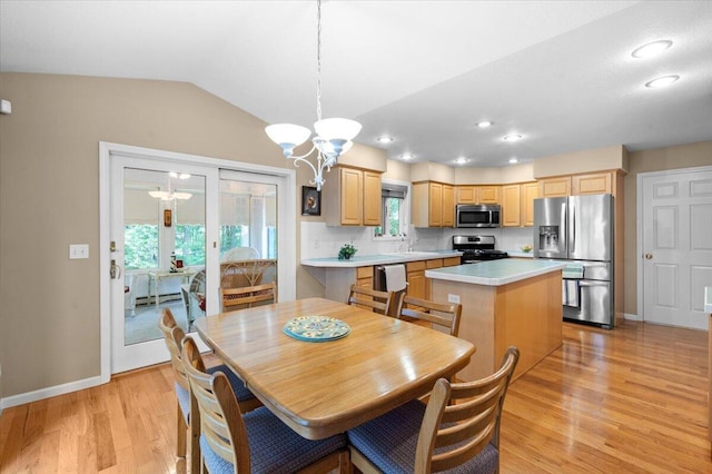 9650 Killdeer Ct, Canadian Lakes, MI 49346 - dining area with a chandelier, light wood-style flooring, vaulted ceiling, and recessed lighting