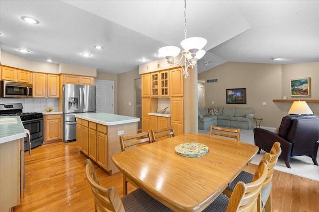 9650 Killdeer Ct, Canadian Lakes, MI 49346 - dining area with light wood finished floors, a chandelier, recessed lighting, and lofted ceiling